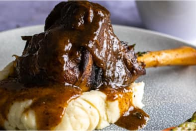 Home Lamb shank on a bed of mashed potatoes Chefiesta Catering